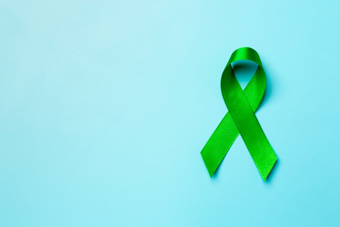 world-mental-health-day-green-ribbon-blue-background